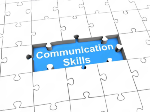 Illustration of a white puzzle with one missing piece revealing the words 'Communication Skills' on a blue background, symbolizing the importance of developing effective communication skills as a crucial part of personal and professional success.