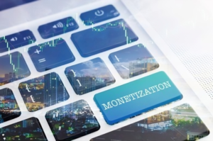 A laptop keyboard with a highlighted blue "Monetization" key, overlaid with digital financial charts and cityscape imagery, representing social media monetization and earning opportunities through online platforms.